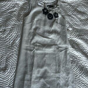 Elegant White Sleeveless Dress with Floral Accents